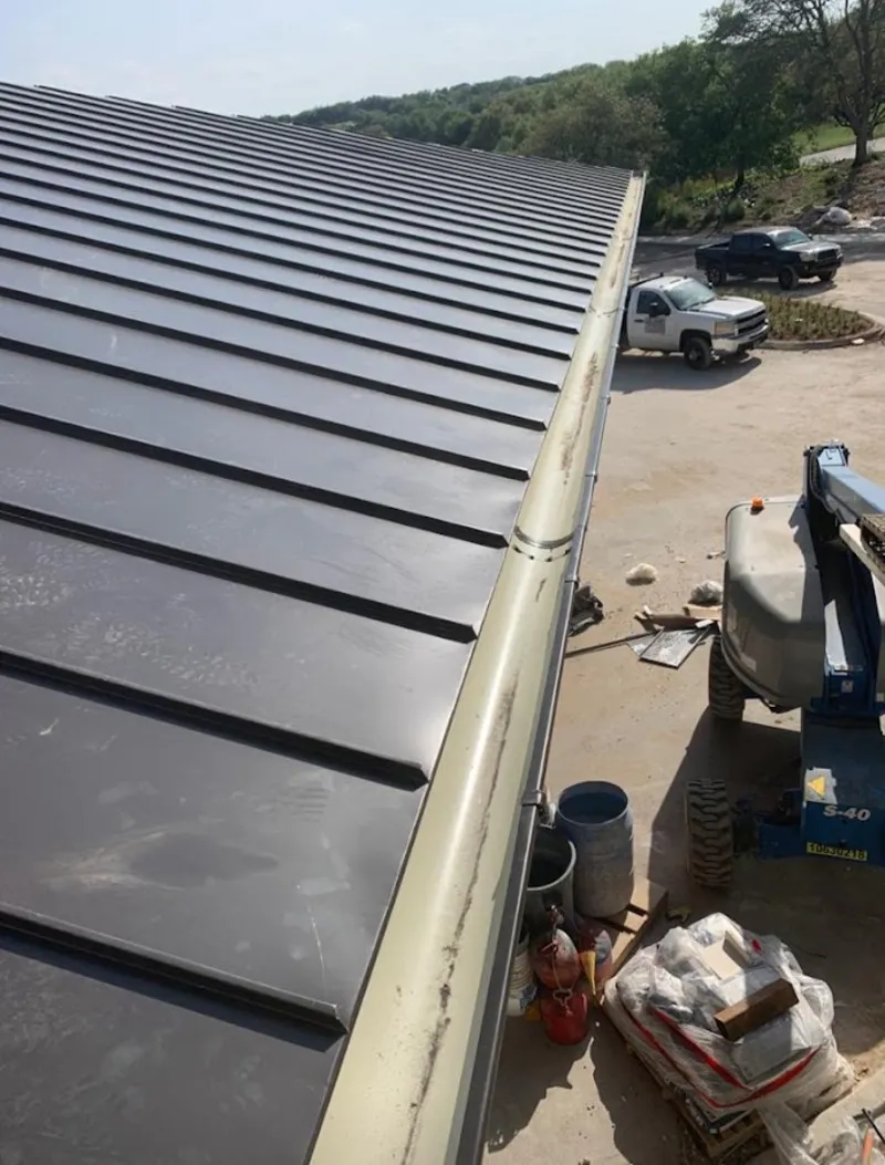 Standing seam panel and gutter detail on a metal roofing jobsite in West Haven-Sylvan